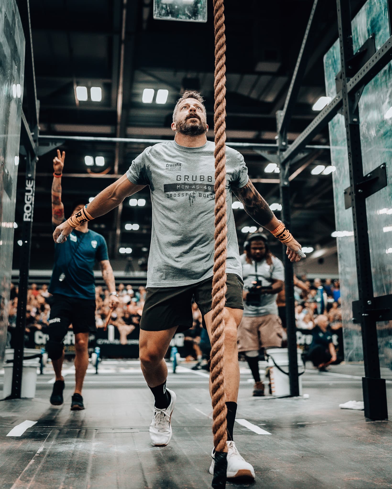 Jason Grubb competing on a rope climb event floor